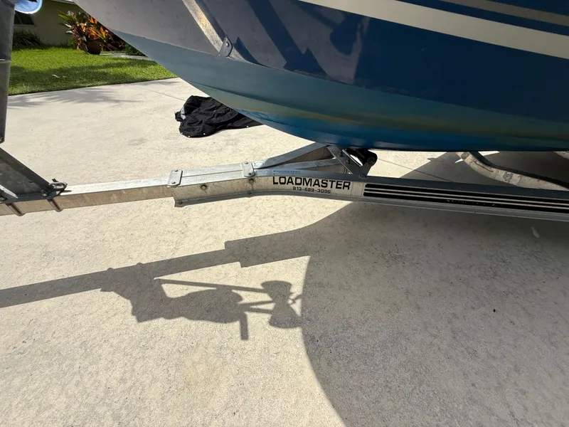Slide: The Image of 2019 Bayliner VR4 Bowrider OB on Loadmaster trailer, parked on concrete driveway. - 19