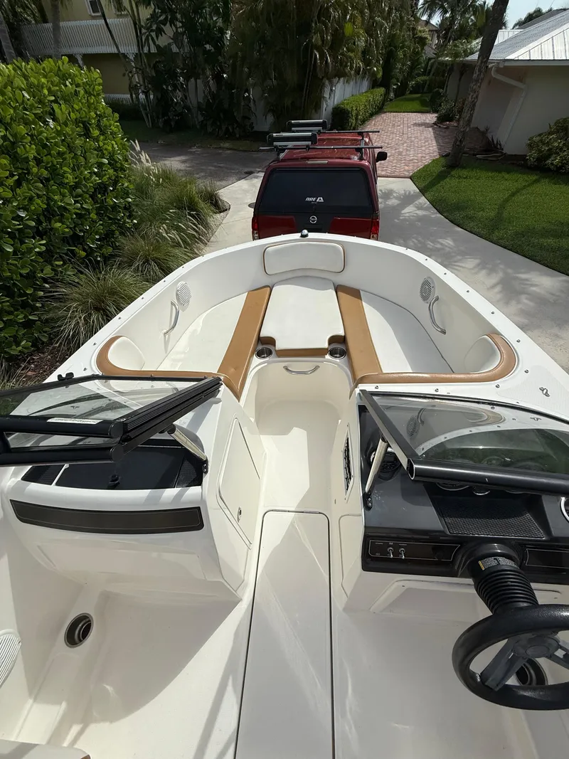 Slide: The Image of 2019 Bayliner VR4 Bowrider OB with tan seating, parked in a driveway. - 2