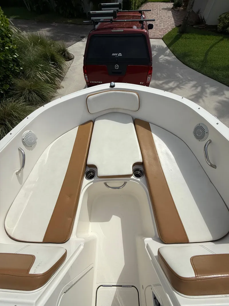 Slide: The Image of 2019 Bayliner VR4 Bowrider OB with tan seating, parked in driveway. - 3