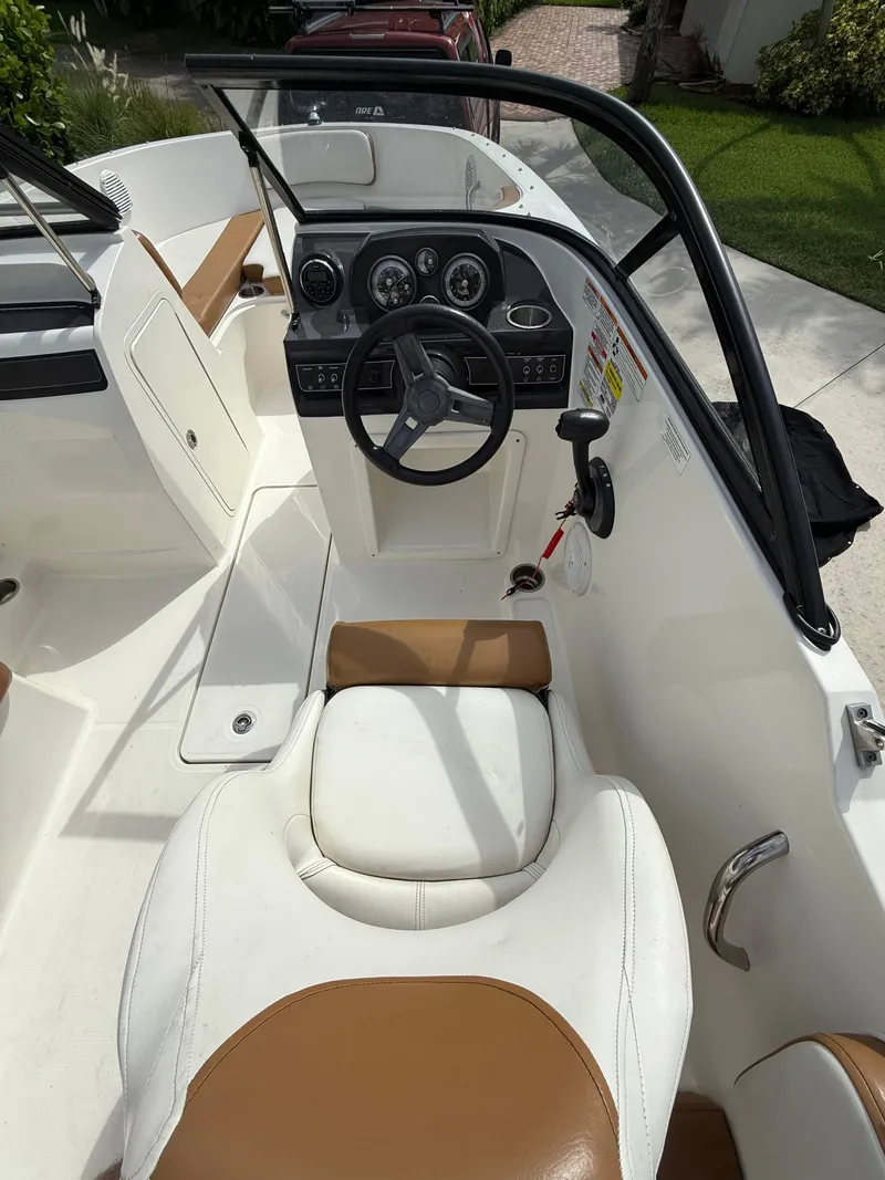Slide: The Image of 2019 Bayliner VR4 Bowrider OB interior with steering wheel and seating. - 5