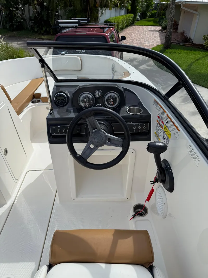 Slide: The Image of 2019 Bayliner VR4 Bowrider OB cockpit with steering wheel and dashboard controls. - 6