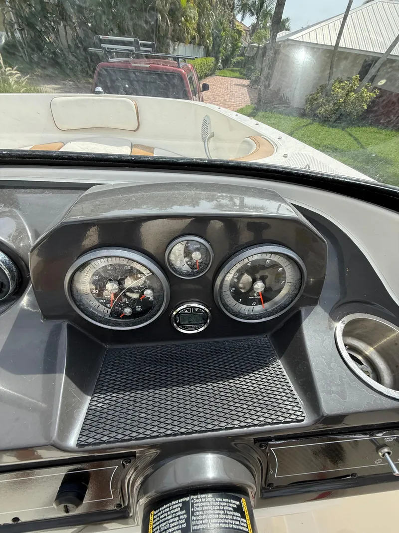 Slide: The Image of 2019 Bayliner VR4 Bowrider OB dashboard with gauges and cup holder. - 7