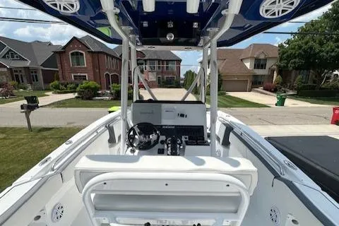 Slide: The Image of 2019 Blackfin 242 CC boat parked in a suburban neighborhood driveway. - 16