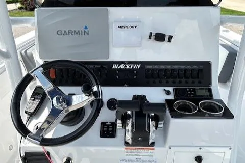 Slide: The Image of 2019 Blackfin 242 CC boat dashboard with Garmin and Mercury controls. - 17