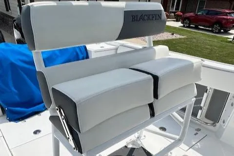 Slide: The Image of 2019 Blackfin 242 CC boat seating with white and gray cushions. - 18