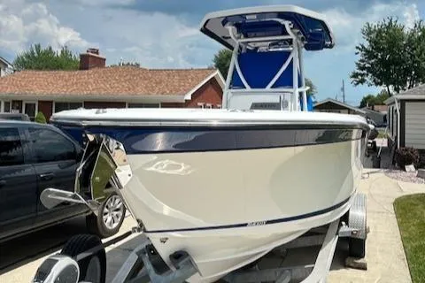 Slide: The Image of 2019 Blackfin 242 CC boat on trailer in residential driveway. - 2