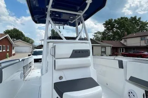 Slide: The Image of 2019 Blackfin 242 CC boat with sleek design, white and black seating, and spacious deck. - 25