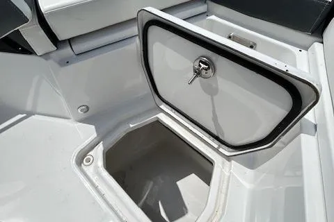 Slide: The Image of 2019 Blackfin 242 CC boat storage compartment with open hatch. - 27
