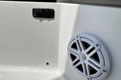 Slide: The Image of 2019 Blackfin 242 CC boat interior with JL Audio speaker and dual outlets. - 29