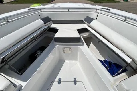 Slide: The Image of 2019 Blackfin 242 CC boat interior with cushioned seating and storage compartments. - 30
