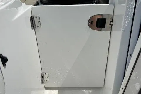 Slide: The Image of 2019 Blackfin 242 CC boat compartment door with stainless steel hinges and latch. - 31