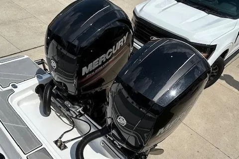Slide: The Image of 2019 Blackfin 242 CC with dual Mercury outboard engines, parked on concrete. - 5