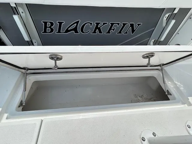 Slide: The Image of 2019 Blackfin 242 CC boat storage compartment with open lid. - 8