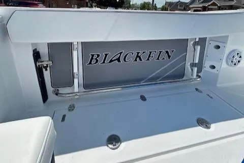 Slide: The Image of 2019 Blackfin 242 CC boat interior with logo, featuring sleek white design. - 9