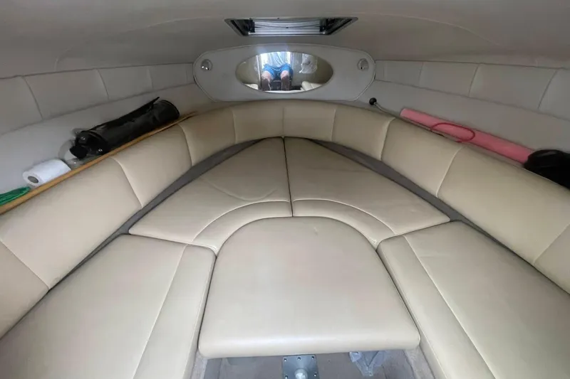Slide: The Image of 2003 Chaparral 235 SSi cabin interior with beige seating and storage compartments. - 10