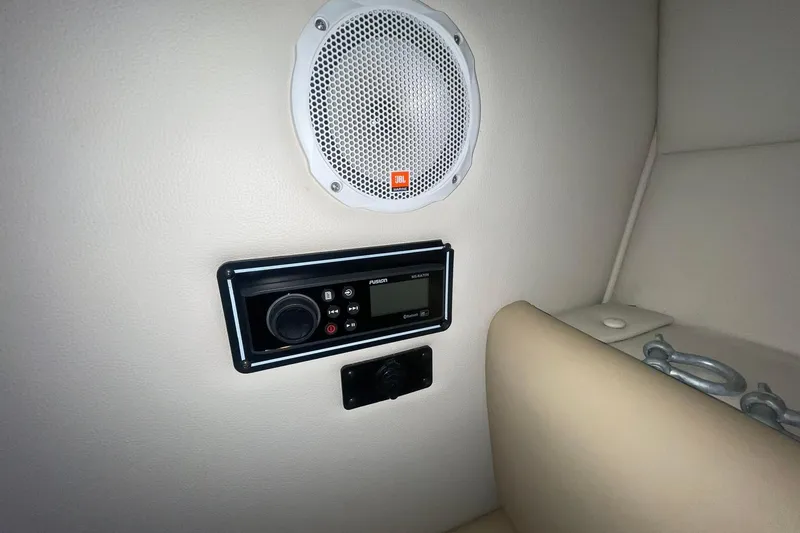 Slide: The Image of 2003 Chaparral 235 SSi boat interior with speaker and audio control panel. - 13