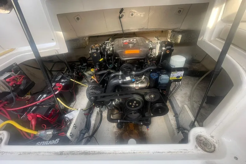 Slide: The Image of Engine compartment of a 2003 Chaparral 235 SSi boat, showing detailed mechanical components. - 14