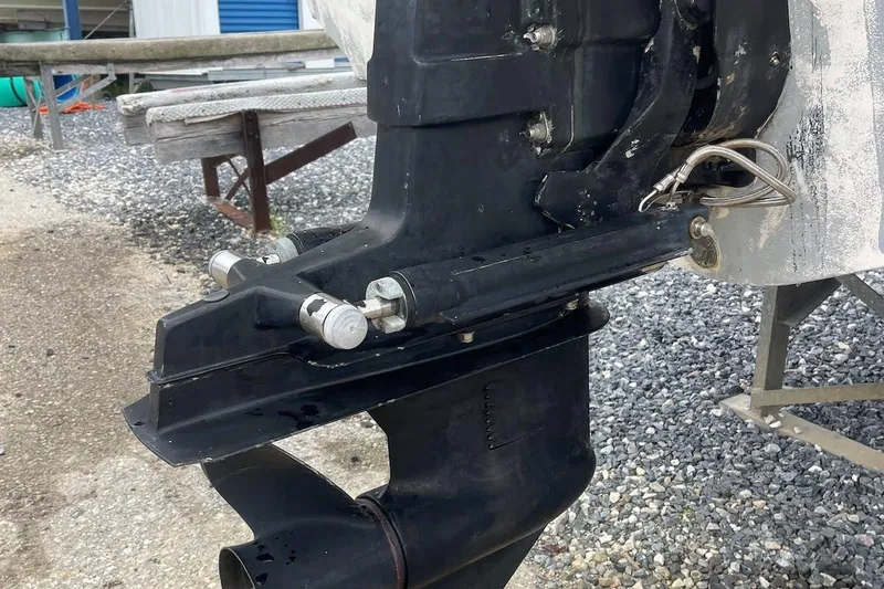 Slide: The Image of Close-up of a 2003 Chaparral 235 SSi boat's outboard motor on a gravel surface. - 17