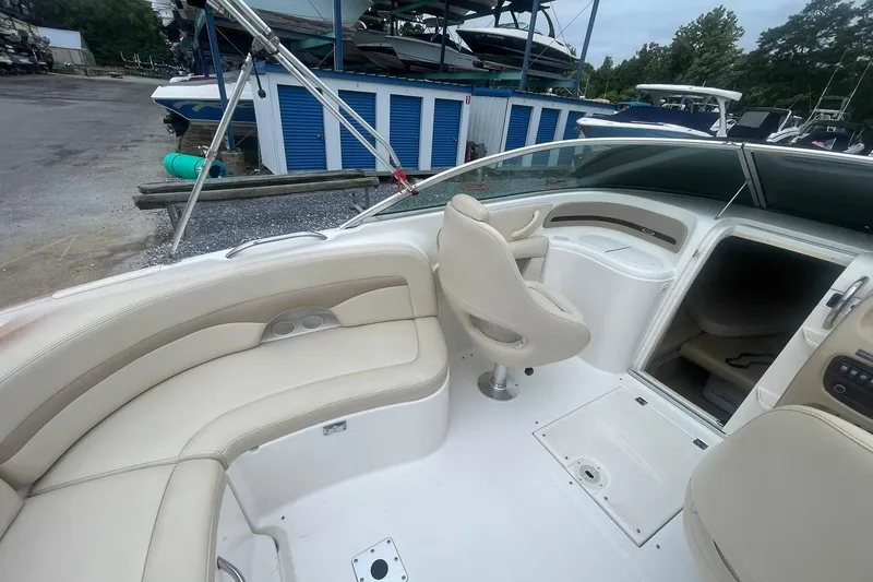 Slide: The Image of 2003 Chaparral 235 SSi boat interior with beige seating and storage compartments. - 5