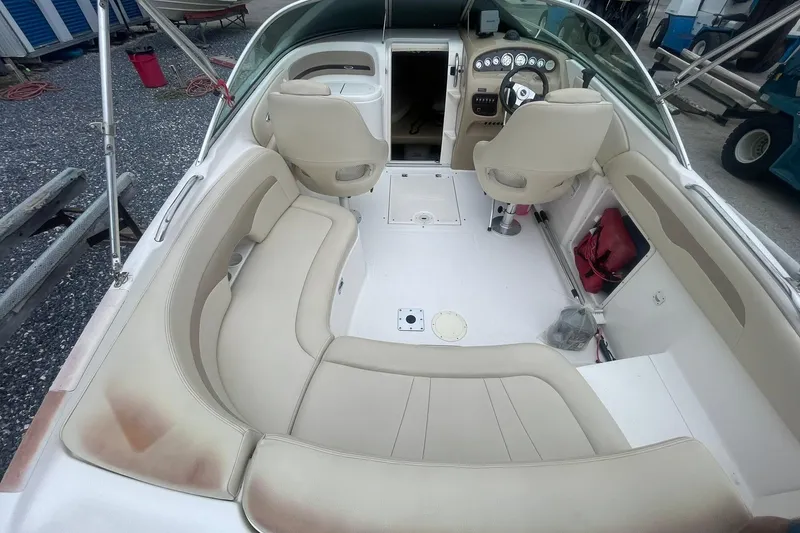 Slide: The Image of 2003 Chaparral 235 SSi boat interior with beige seating and steering console. - 6