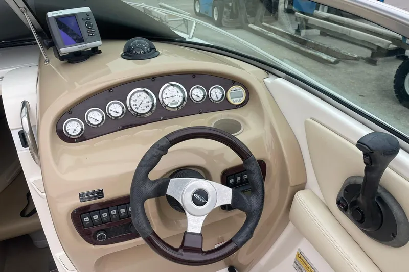 Slide: The Image of 2003 Chaparral 235 SSi boat dashboard with steering wheel, gauges, and controls. - 8