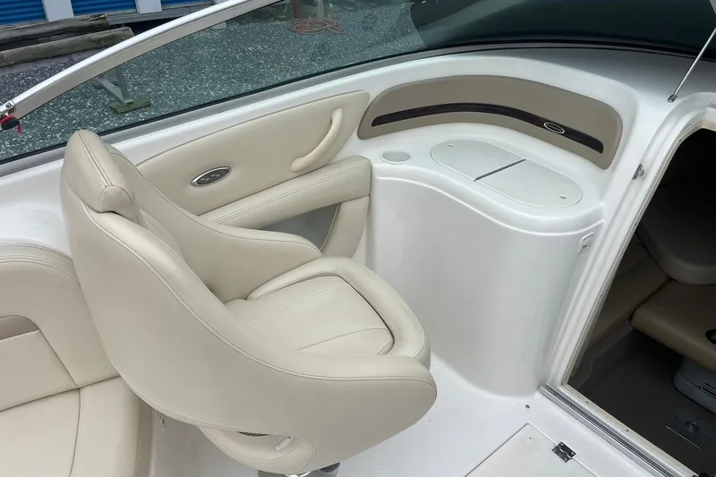 Slide: The Image of 2003 Chaparral 235 SSi boat interior with beige seating and storage compartment. - 9