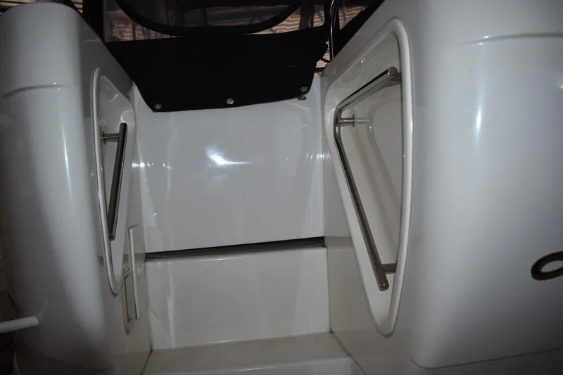 Slide: The Image of Staircase on 2000 Cruisers Yachts 4450 Express Motoryacht, featuring sleek white design and metal railings. - 10