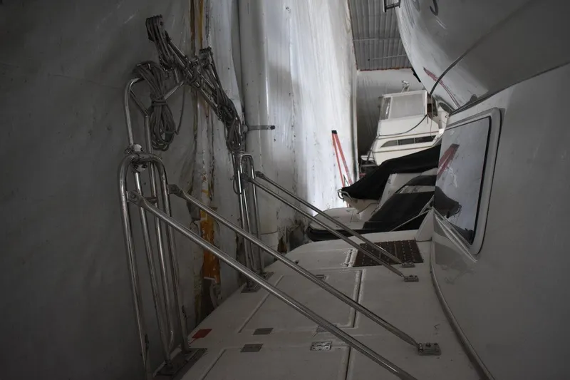 Slide: The Image of 2000 Cruisers Yachts 4450 Express Motoryacht in storage, showing deck and railing details. - 16