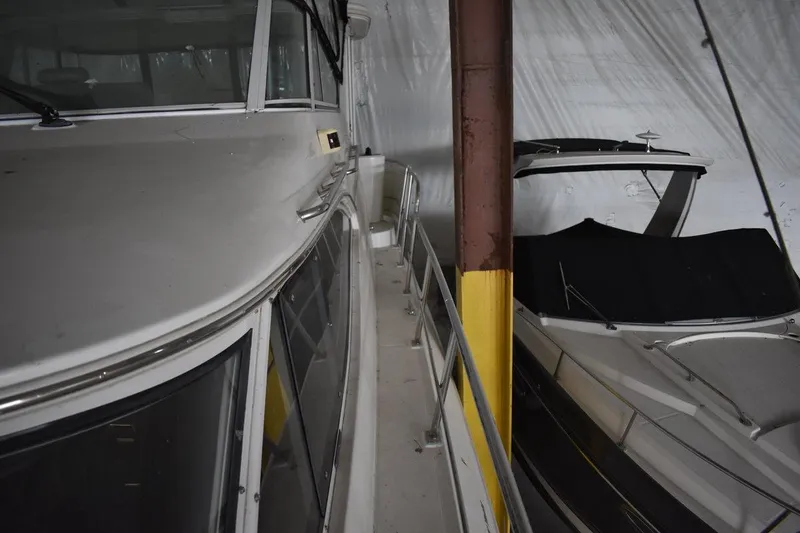 Slide: The Image of 2000 Cruisers Yachts 4450 Express Motoryacht docked indoors, side view. - 17