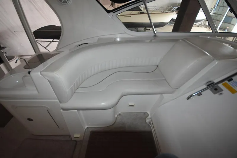 Slide: The Image of 2000 Cruisers Yachts 4450 Express Motoryacht interior seating area with white upholstery. - 21