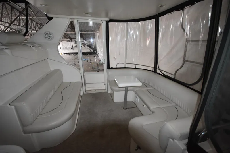 Slide: The Image of Interior of 2000 Cruisers Yachts 4450 Express Motoryacht with white seating and table. - 22