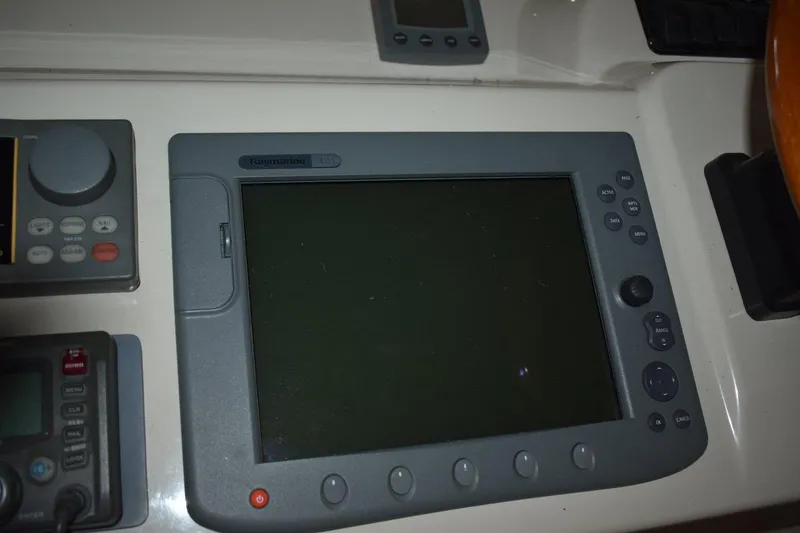 Slide: The Image of Control panel of a 2000 Cruisers Yachts 4450 Express Motoryacht with Raymarine display. - 31