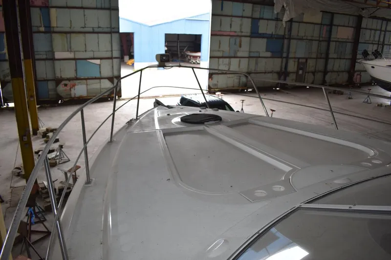 Slide: The Image of 2000 Cruisers Yachts 4450 Express Motoryacht in a spacious indoor storage facility. - 35