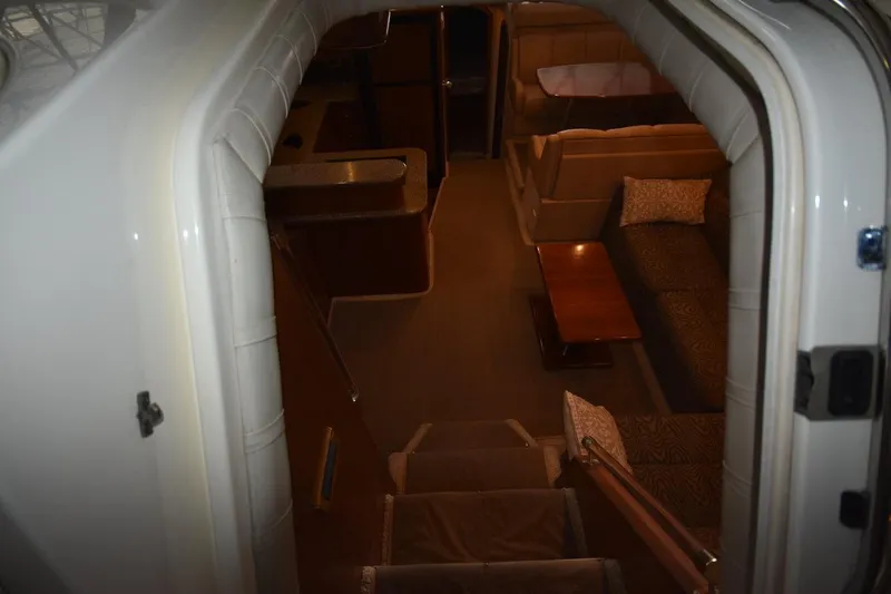 Slide: The Image of Interior view of 2000 Cruisers Yachts 4450 Express Motoryacht, featuring cozy seating and elegant design. - 37