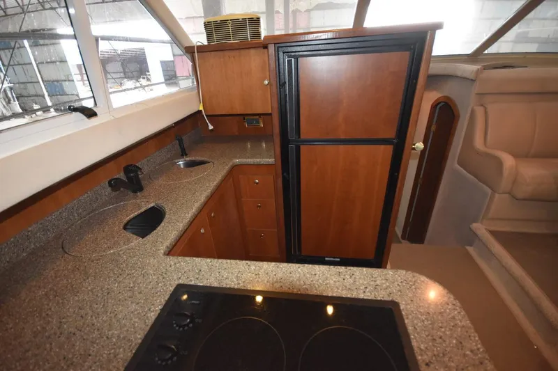 Slide: The Image of Luxurious 2000 Cruisers Yachts 4450 Express Motoryacht kitchen with modern amenities. - 38