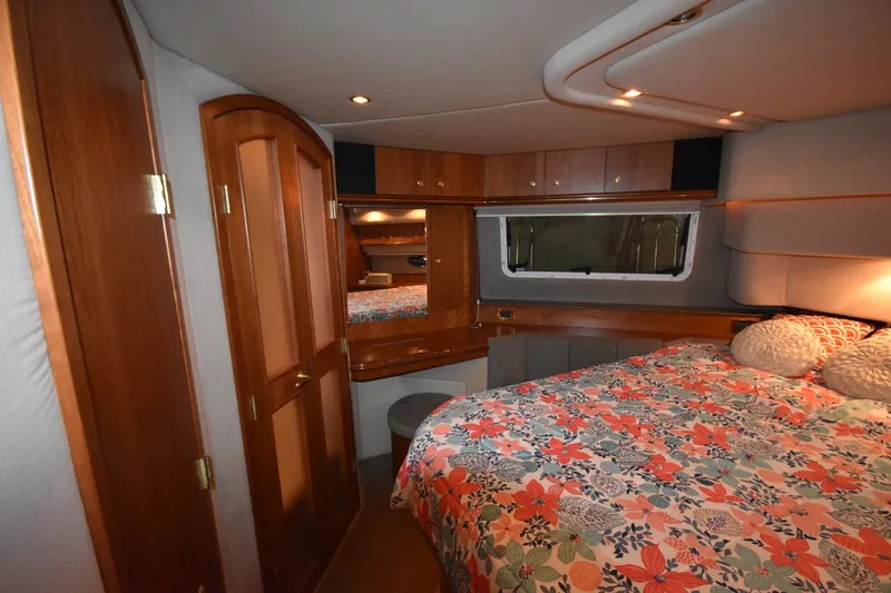 Slide: The Image of Luxurious cabin interior of 2000 Cruisers Yachts 4450 Express Motoryacht with floral bedding. - 48