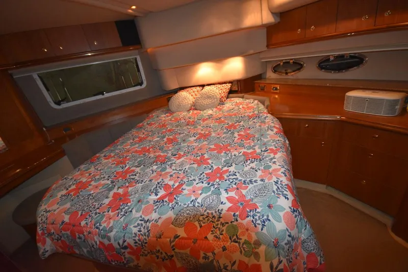 Slide: The Image of Luxurious bedroom interior of 2000 Cruisers Yachts 4450 Express Motoryacht with floral bedding. - 49
