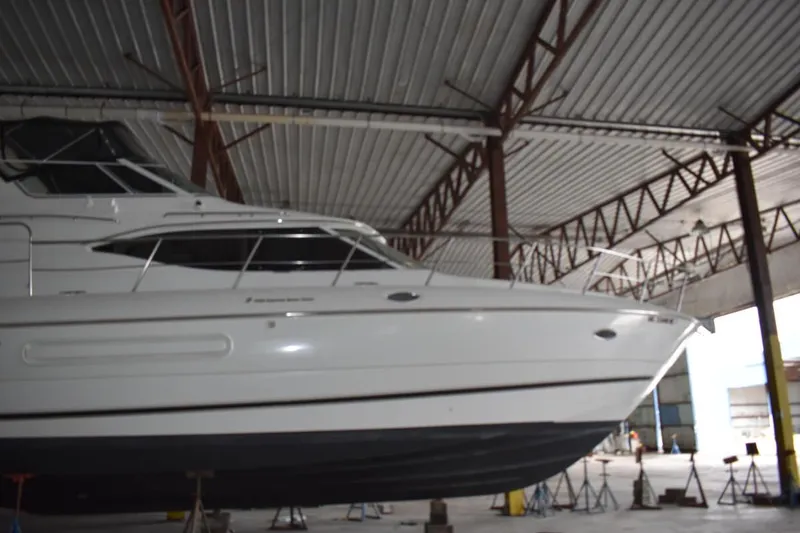 Slide: The Image of 2000 Cruisers Yachts 4450 Express Motoryacht in a covered storage facility. - 6