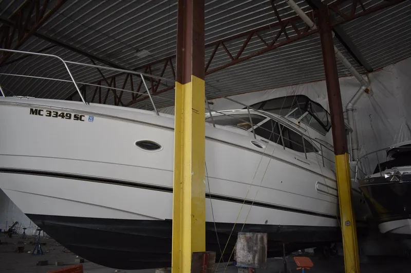 Slide: The Image of 2000 Cruisers Yachts 4450 Express Motoryacht stored indoors, side view. - 7