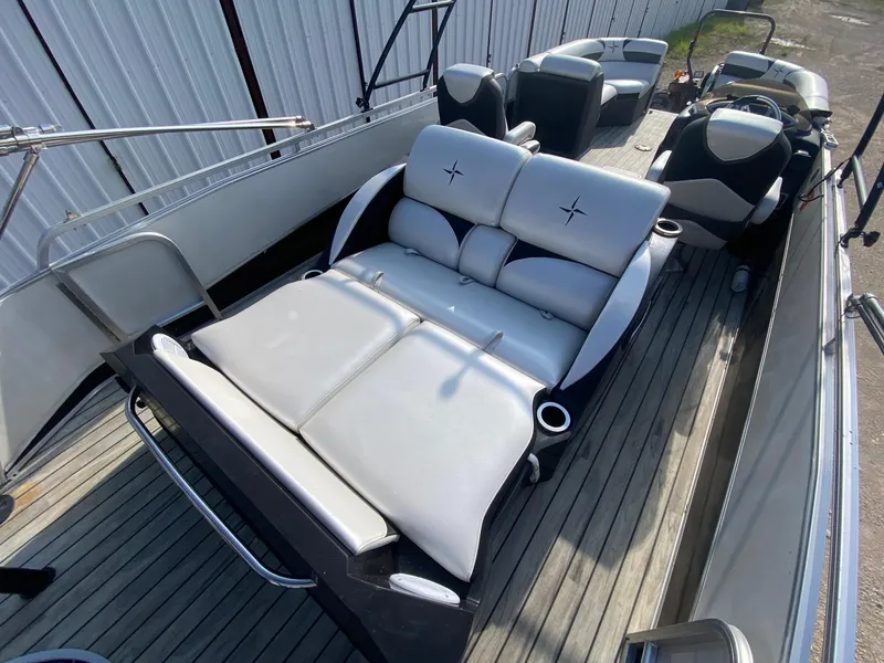 Slide: The Image of 2015 Berkshire 233SL STS boat interior with white seating and wooden deck. - 11