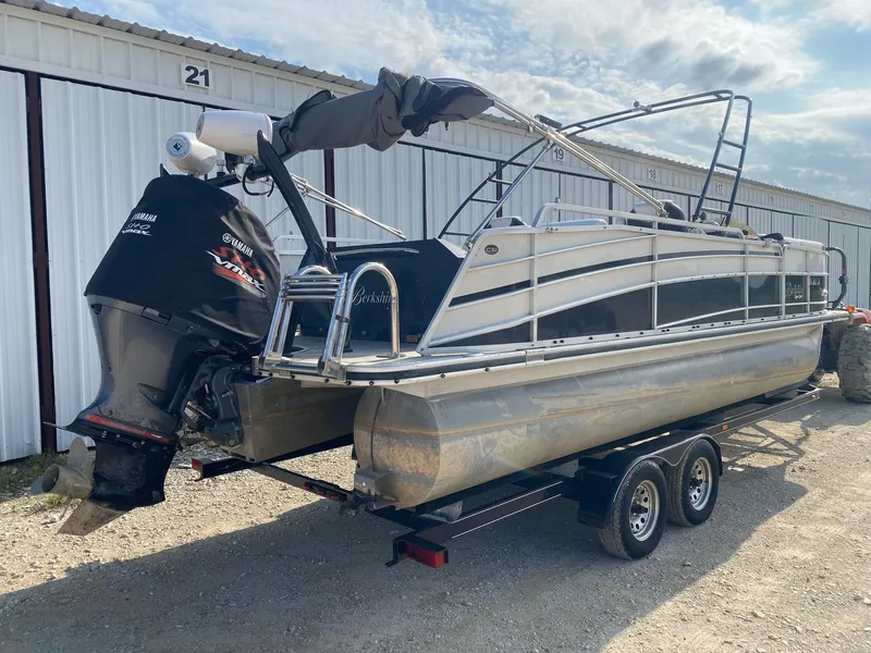 Slide: The Image of 2015 Berkshire 233SL STS pontoon boat on trailer, Yamaha outboard motor, parked outdoors. - 5