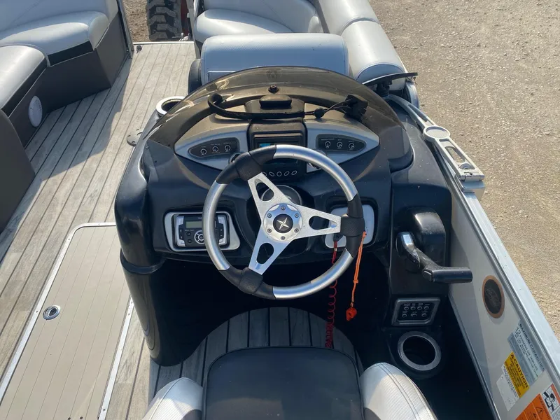 Slide: The Image of Steering console of a 2015 Berkshire 233SL STS pontoon boat with modern controls. - 6