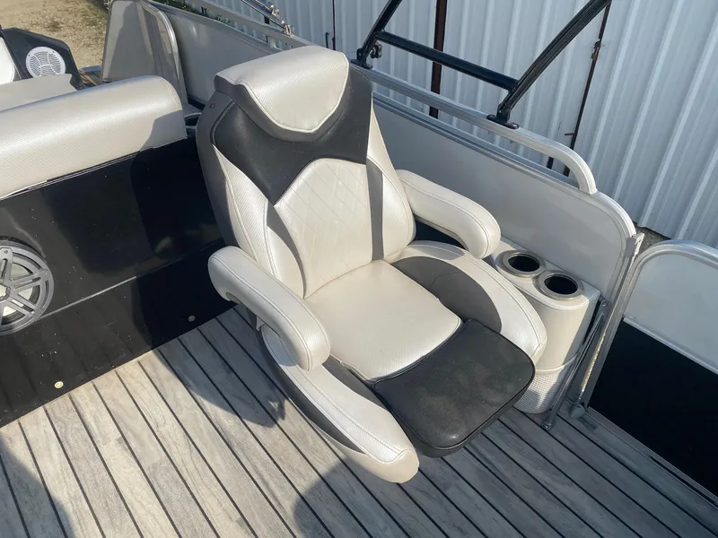 Slide: The Image of Luxury seating on 2015 Berkshire 233SL STS boat with cup holders and speaker. - 8
