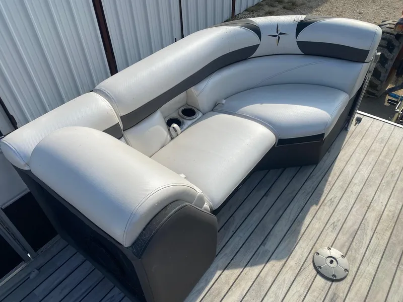 Slide: The Image of 2015 Berkshire 233SL STS boat seating on wooden deck, featuring cup holders. - 9
