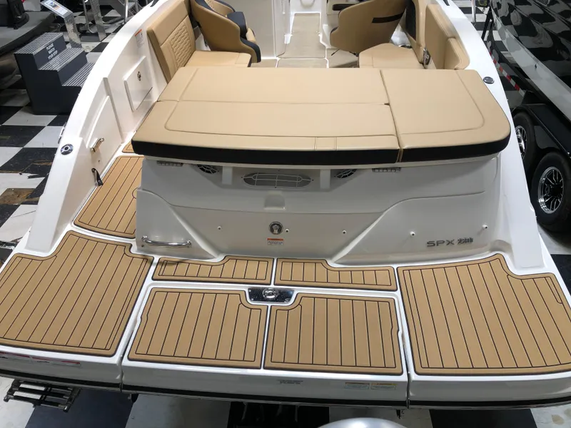 Slide: The Image of 2025 Sea Ray SPX 230 boat with tan seating and teak-style decking. - 3