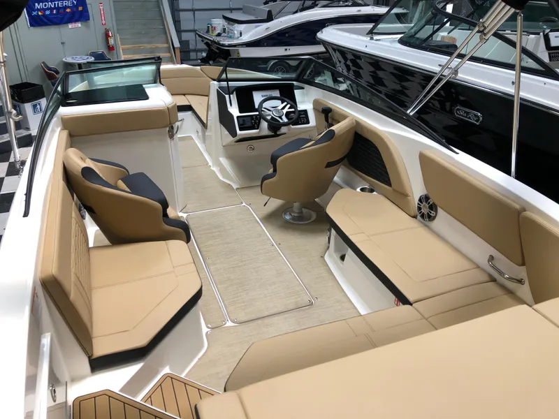 Slide: The Image of 2025 Sea Ray SPX 230 boat interior with tan seating and modern dashboard. - 4