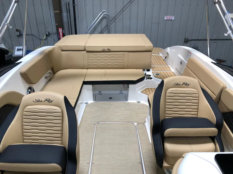 Slide: The Image of 2025 Sea Ray SPX 230 boat interior with beige and black seating, showcasing luxury design. - 8