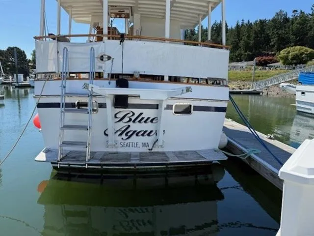 Slide: The Image of 1983 Ocean Alexander 43 Flush Aft Deck yacht docked in a marina, named "Blue Agave." - 11