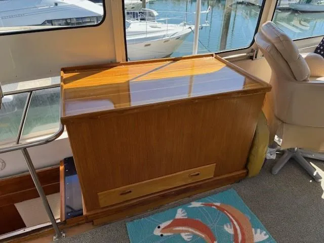 Slide: The Image of 1983 Ocean Alexander 43 Flush Aft Deck interior with wooden cabinet with freezer inside - 23