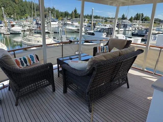 Slide: The Image of 1983 Ocean Alexander 43 Flush Aft Deck yacht with wicker seating, marina view. - 27